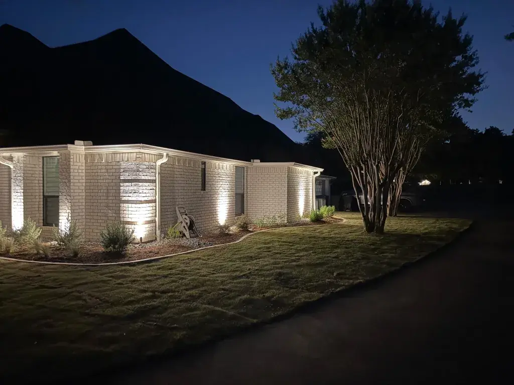 Southlake LED wall-wash columns and eave lighting along a white brick exterior at twilight