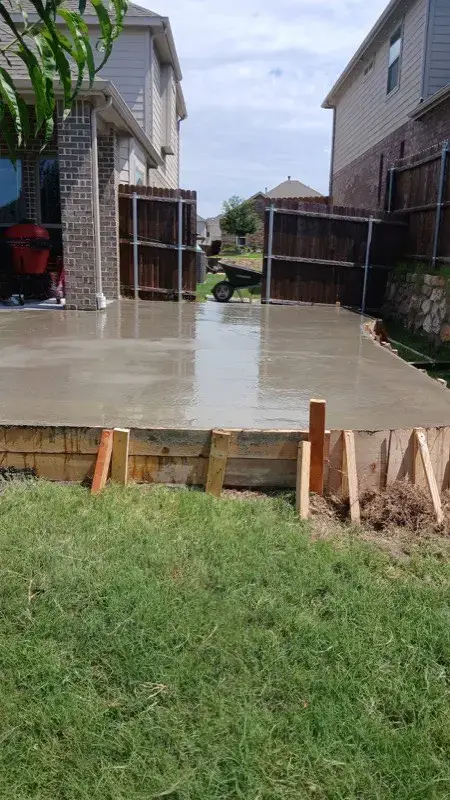 Newly poured concrete patio slab with wood forms still in place